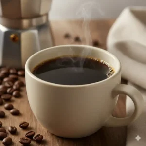 A fresh, full cup of rich, dark coffee brewed using a high-quality stovetop percolator.